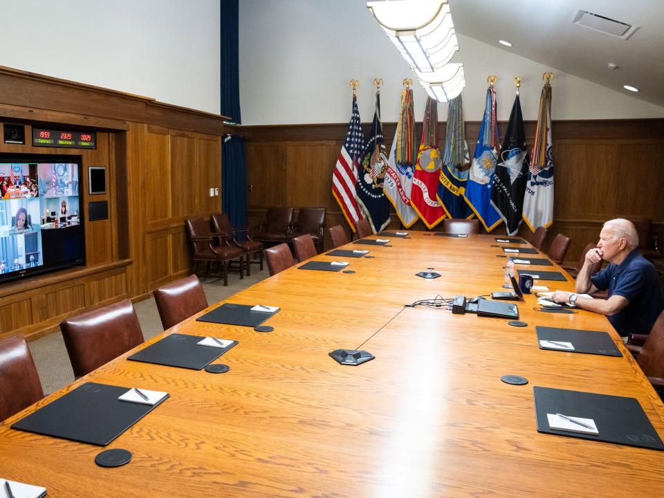 U.S. President Joe Biden and Vice President Kamala Harris (on screen) hold a video conference with the national security team to discuss the ongoing efforts to draw down our civilian footprint in Afghanistan