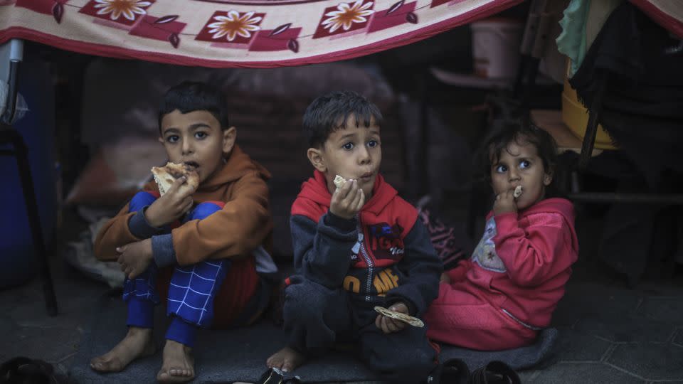 Palestinian children take shelter at a school run by the United Nations Relief and Works Agency for Palestine Refugees in the Near East (UNRWA), in the city of Khan Yunis, in southern Gaza, on November 15. Displaced civilians told CNN the arrival of winter in Gaza further threatens their survival. - Mohammed Talatene/picture-alliance/dpa/AP