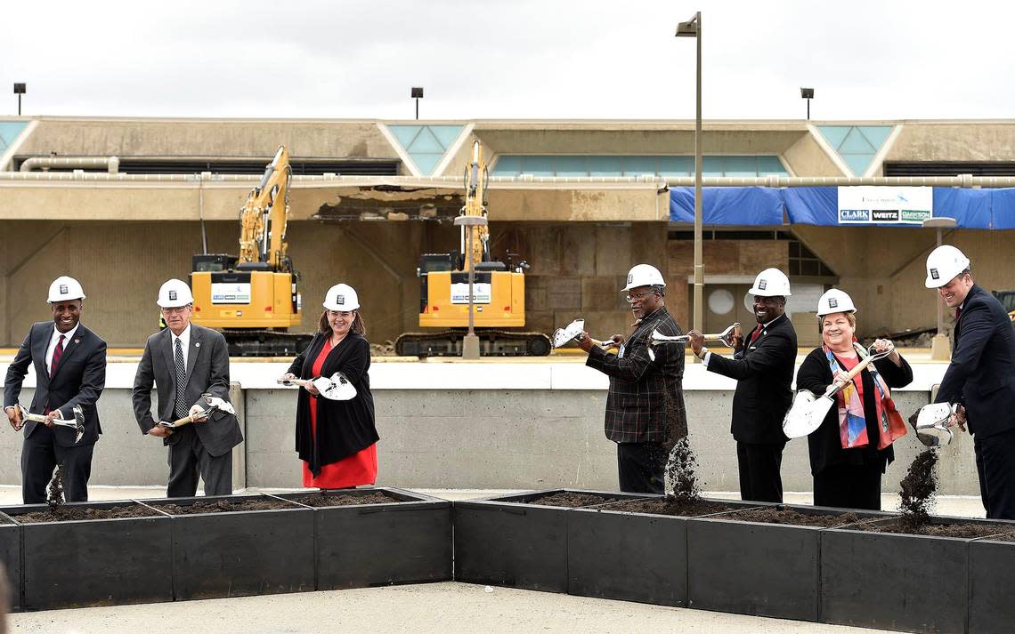 With a small part of Terminal A already torn down behind them, city leaders broke ground March 25, 2019, for the new Kansas City International Airport single terminal. From left: city council members Quinton Lucas, Dan Fowler, Jolie Justus, Mayor Sly James, Jermaine Reed, Katheryn Shields and Kevin McManus.