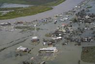 Buildings and homes are flooded in the aftermath of Hurricane Laura Thursday, Aug. 27, 2020, in Cameron, La. (AP Photo/David J. Phillip)