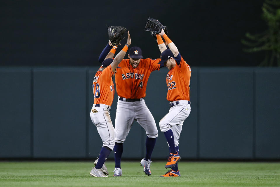 Houston Astros outfielders Tony Kemp, from left, George Springer and Josh Reddick dance after the first baseball game of a doubleheader against the Baltimore Orioles, Saturday, Sept. 29, 2018, in Baltimore. Houston won 4-3. (AP Photo/Patrick Semansky)