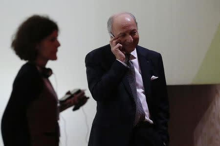 French Foreign Affairs Minister Laurent Fabius (R), President-designate of COP21, speaks on the phone before the final session at the World Climate Change Conference 2015 (COP21) at Le Bourget, near Paris, France, December 12, 2015. REUTERS/Stephane Mahe