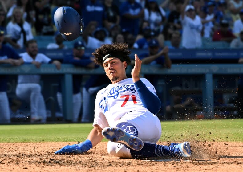 Los Angeles, California October 4 2022-Dodgers Miguel Vargas slides to score a run against the Rockies in the seventh inning at Dodger Stadium Wednesday. (Wally Skalij/Los Angeles Times)