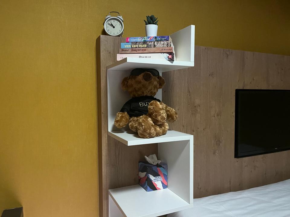 Modern shelving filled with books, teddy bears, and other trinkets