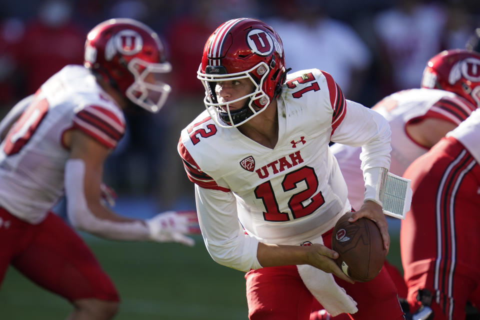 Utah quarterback Charlie Brewer (12) looks to hand off the ball during the first half of an NCAA college football game against San Diego State Saturday, Sept. 18, 2021, in Carson, Calif. (AP Photo/Ashley Landis)