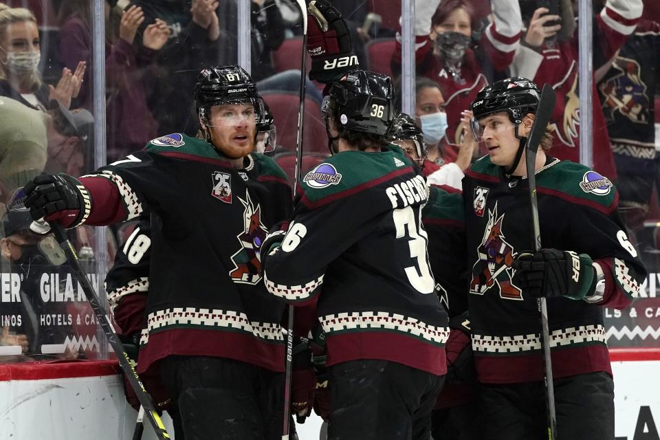 Arizona Coyotes left wing Lawson Crouse (67), Coyotes right wing Christian Fischer (36), and Coyotes defenseman Jakob Chychrun (6) celebrate a goal against the Los Angeles Kings by Coyotes' Christian Dvorak during the first period of an NHL hockey game Monday, May 3, 2021, in Glendale, Ariz. (AP Photo/Ross D. Franklin)