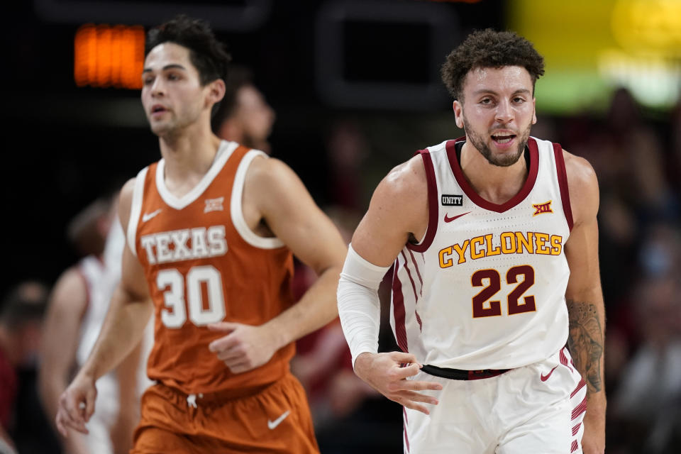 Iowa State guard Gabe Kalscheur (22) celebrates in front of Texas forward Brock Cunningham (30) after making a 3-point basket during the second half of an NCAA college basketball game, Saturday, Jan. 15, 2022, in Ames, Iowa. (AP Photo/Charlie Neibergall)