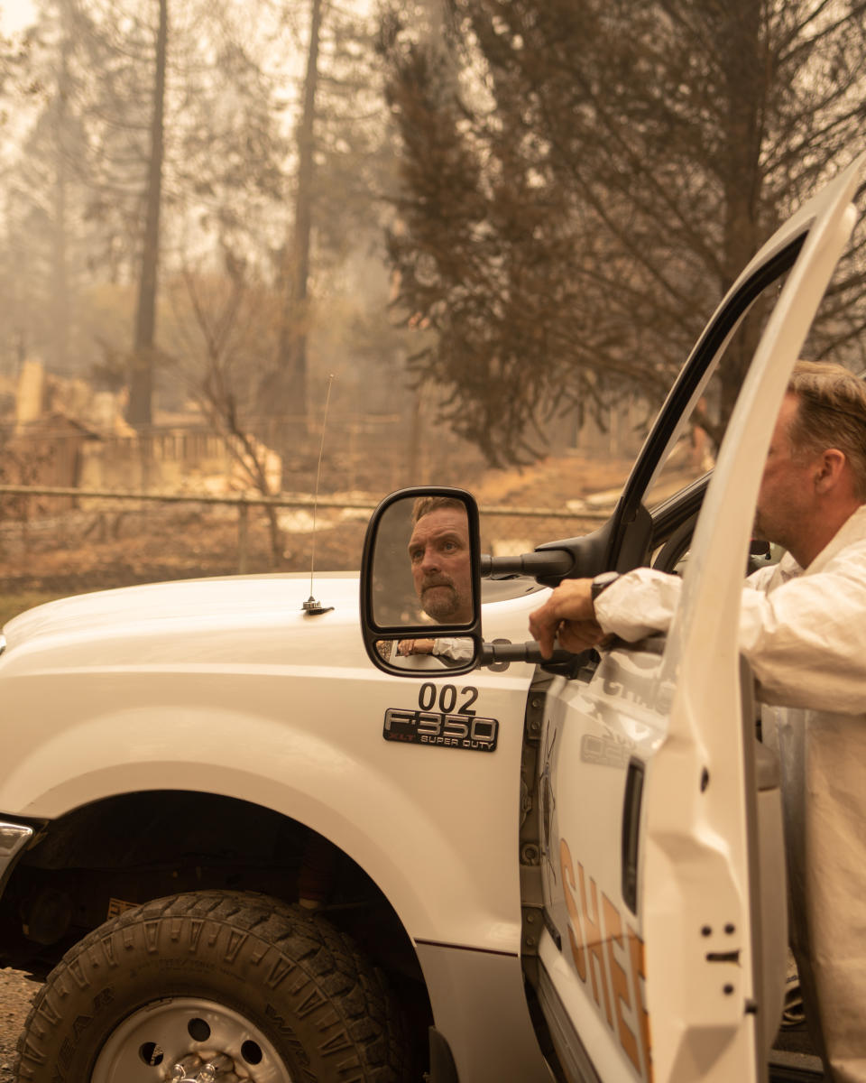 A member of the Tuolumne Sheriff Search &amp; Rescue team looks down the street of a neighborhood in Paradise that was destroyed by the Camp fire. (Photo: Cayce Clifford for HuffPost)