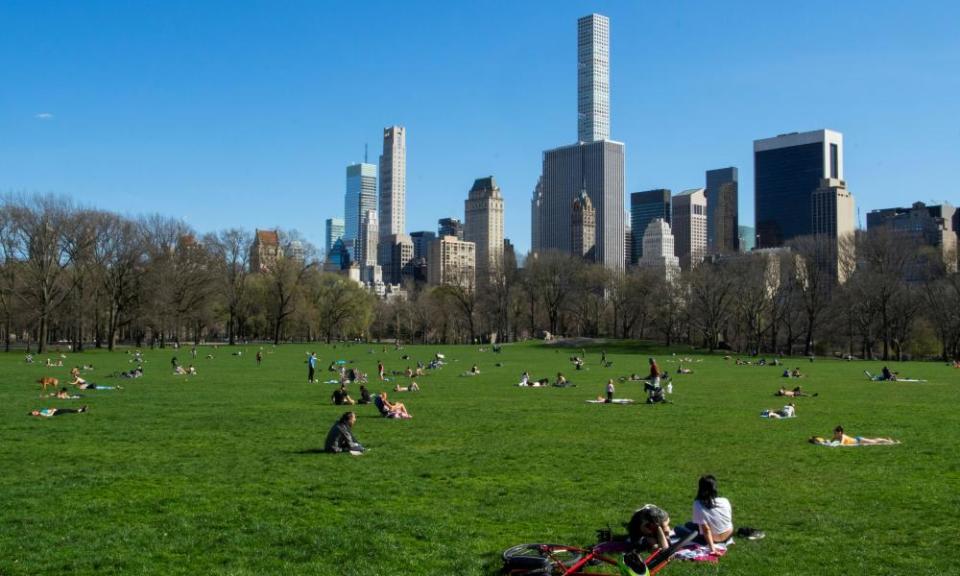 People follow social distancing rules on a sunny day in Central Park, New York.