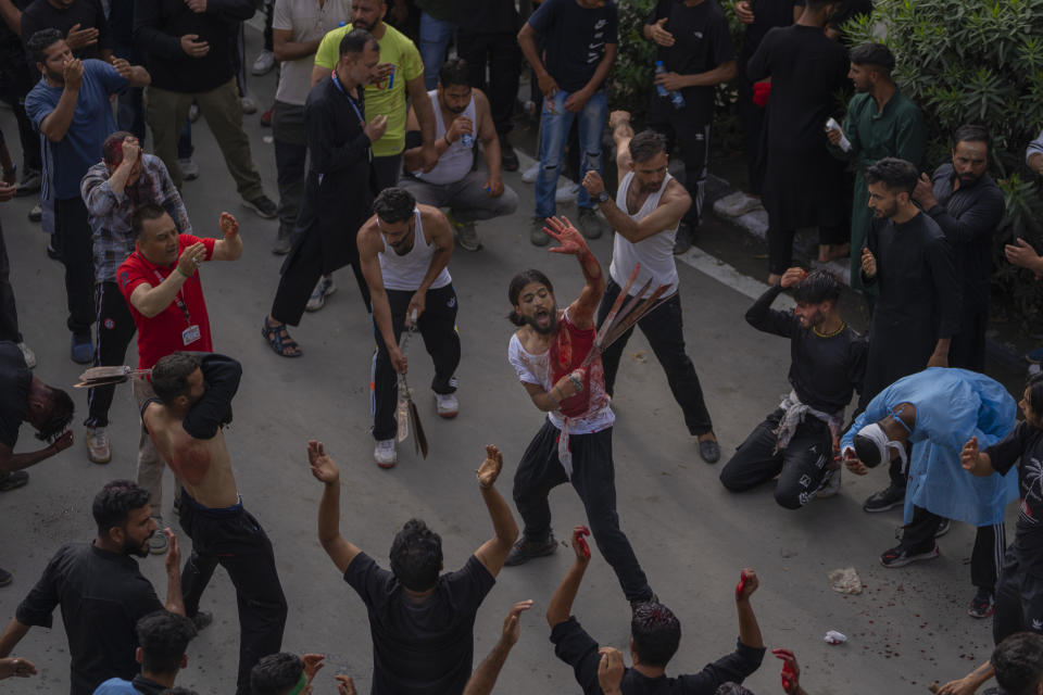 Kashmiri Shiite muslims flagellate themselves during a Muharram procession in Srinagar, Indian controlled Kashmir, Thursday, July 27, 2023. Muharram is a month of mourning for Shiite Muslims in remembrance of the martyrdom of Imam Hussein, the grandson of the Prophet Muhammad. (AP Photo/Dar Yasin)