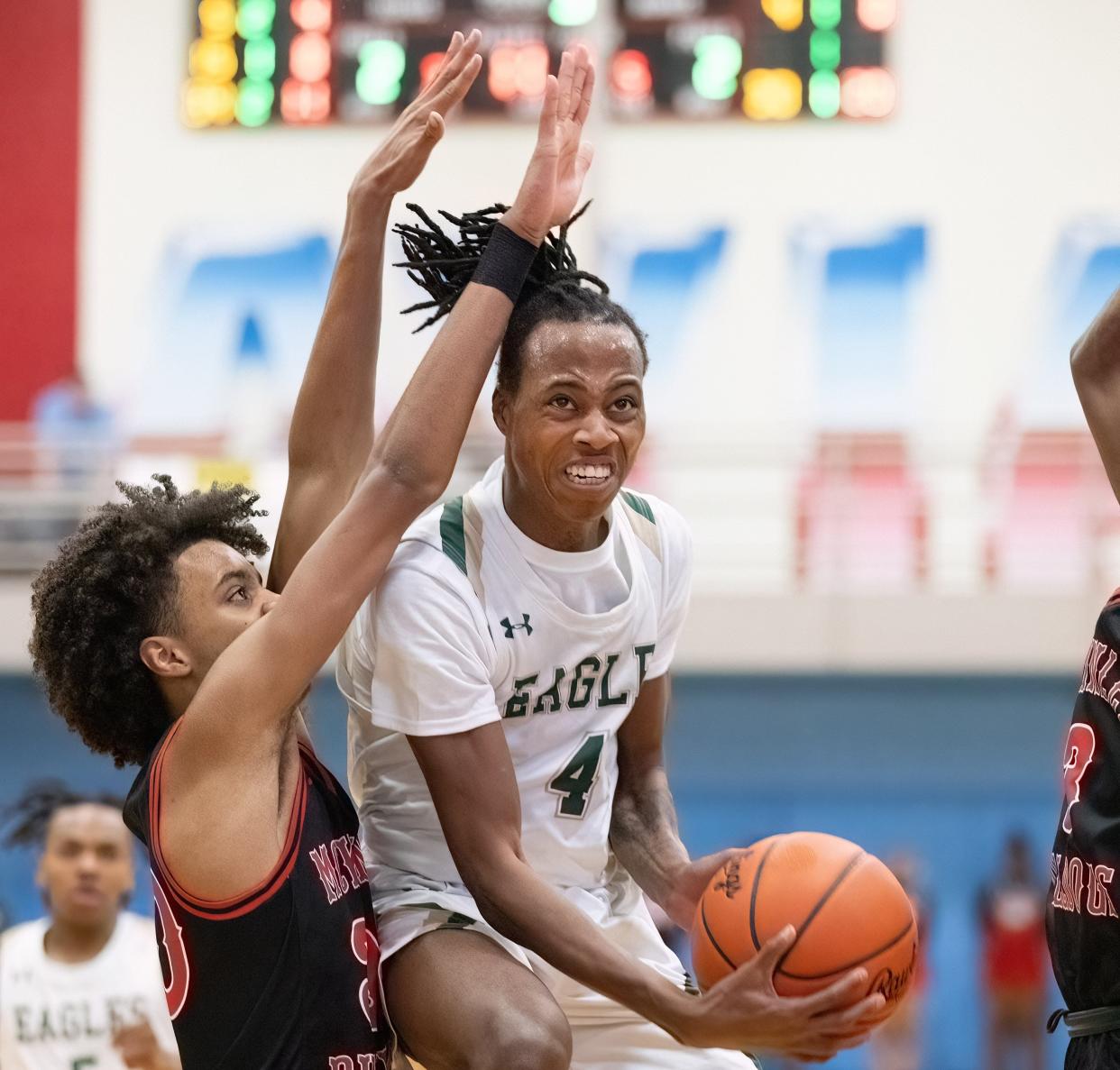 GlenOak’s Jaylen McElroy drives to the basket past McKinley’s Reed Sims Jr. during a district semifinal, Thursday, March 7, 2024.