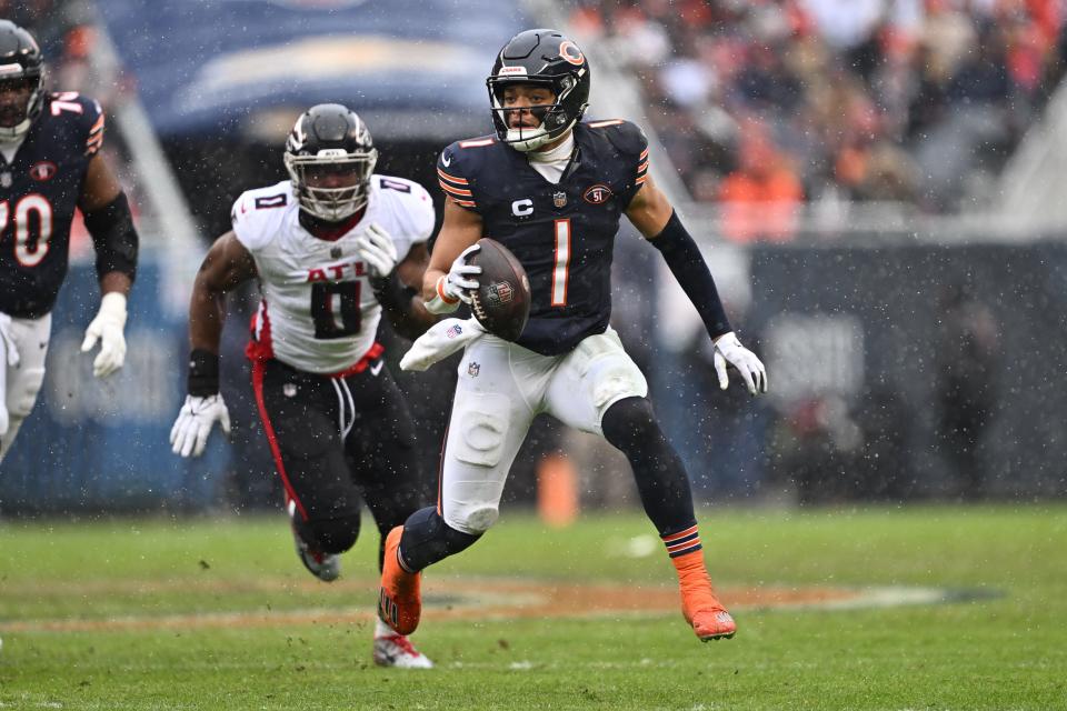 Chicago Bears quarterback Justin Fields (1) scrambles for yards in the first half against the Atlanta Falcons at Soldier Field.