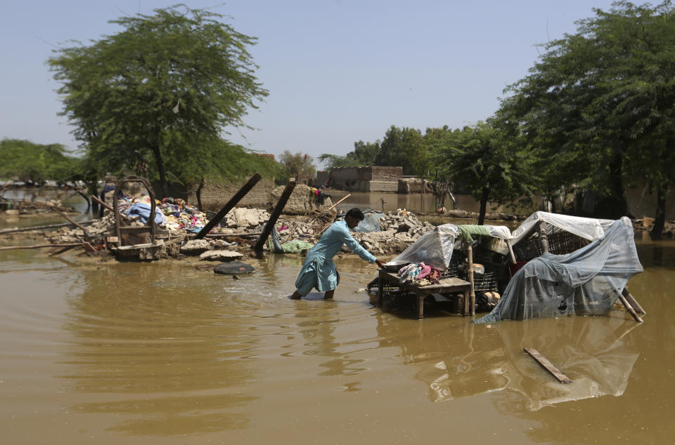 A man looks for salvageable belongings from his flood-damaged home in the Shikarpur district of Sindh Province, Pakistan, Thursday, Sept. 1, 2022. Pakistani health officials on Thursday reported an outbreak of waterborne diseases in areas hit by recent record-breaking flooding, as authorities stepped up efforts to ensure the provision of clean drinking water to hundreds of thousands of people who lost their homes in the disaster. (AP Photo/Fareed Khan)