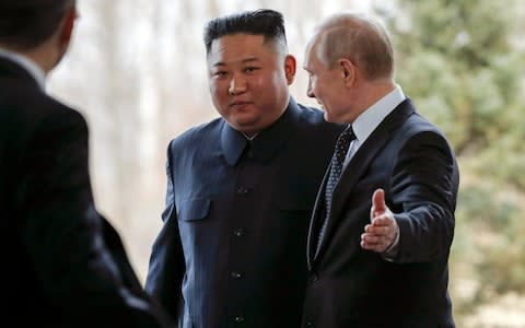 Russian President Vladimir Putin, right, welcomes North Korea's leader Kim Jong Un during their meeting in Vladivostok - Credit: AP