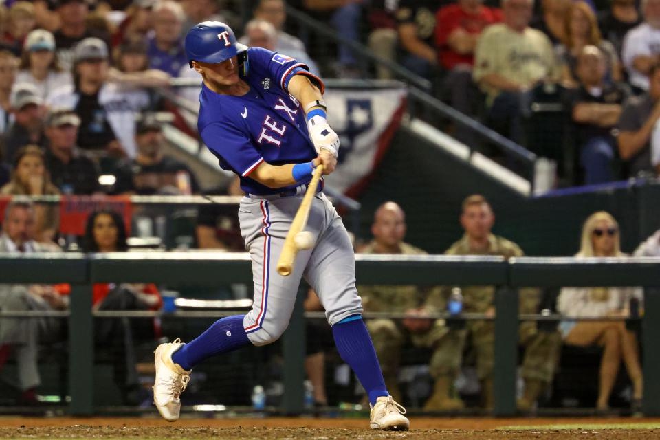 Texas Rangers third baseman Josh Jung (6) hits a single against the Arizona Diamondbacks during the ninth inning in game five of the 2023 World Series at Chase Field.