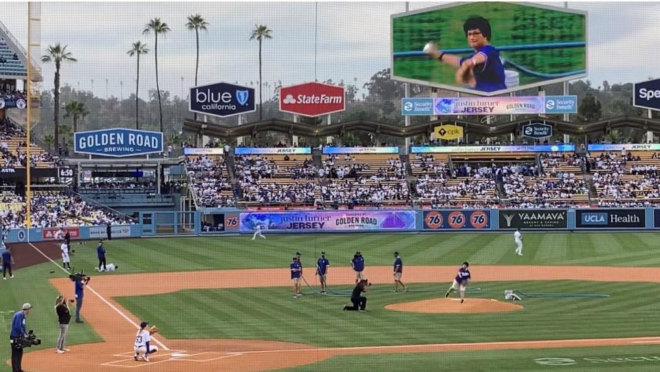 Palm Springs resident Denise Goolsby throws out the ceremonial first pitch at the Dodgers game Thursday while her image is shown on the big screen.