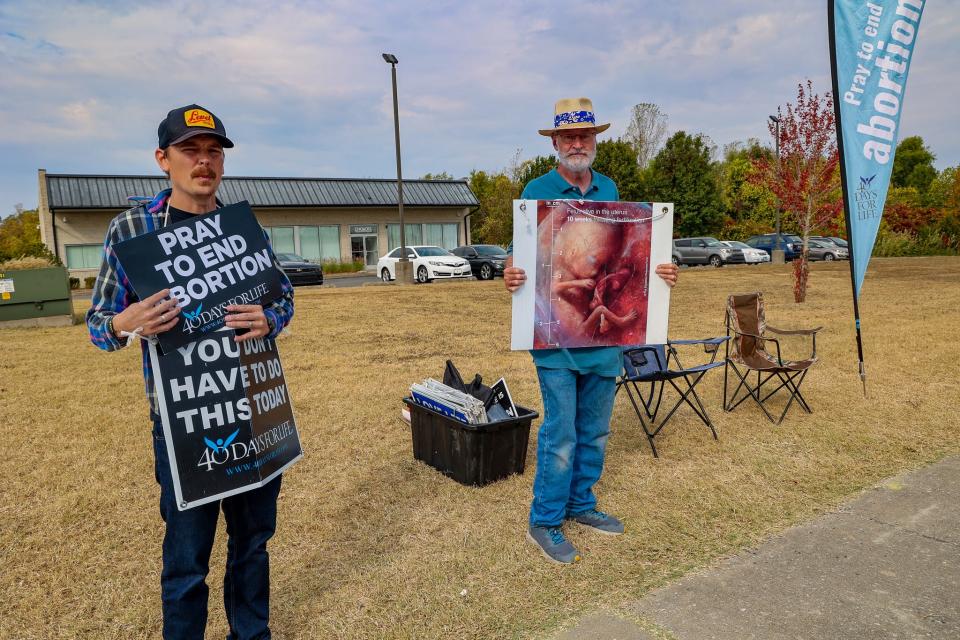 Anti-abortion protesters stand outside the first of a least two new abortion clinics opening in Carbondale, Illinois, on Tuesday, Oct. 11, 2022.