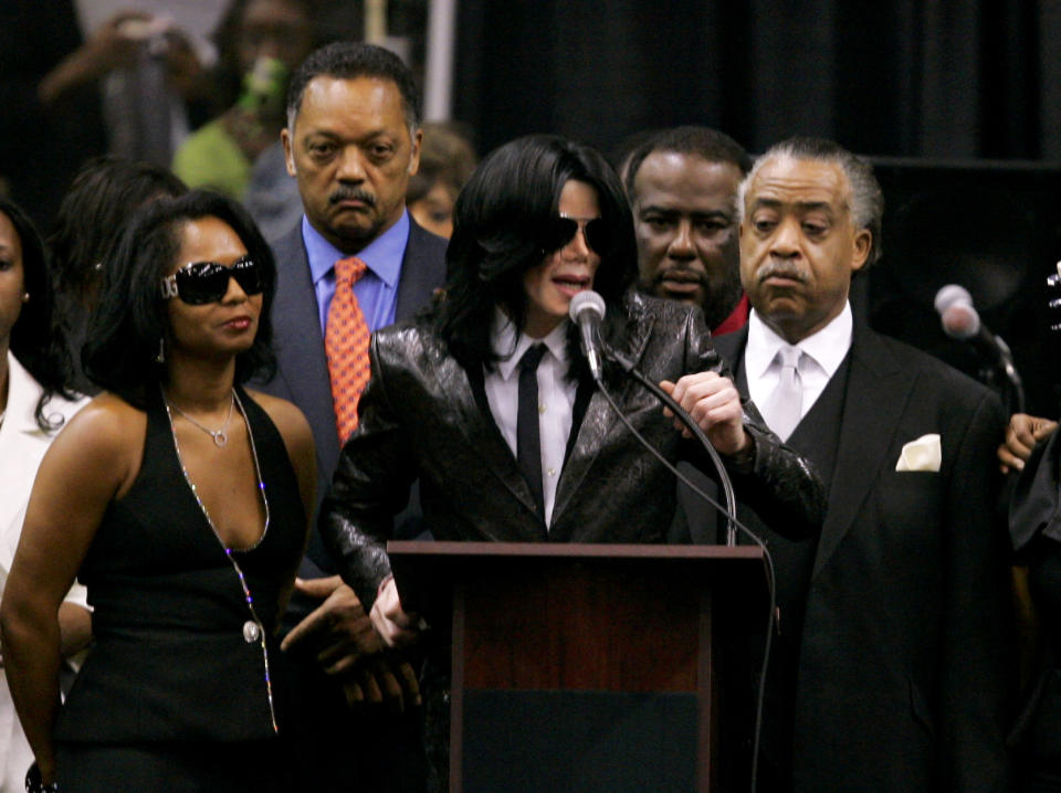 FILE - In this Dec. 30, 2006 file photo, Michael Jackson speaks at the podium flanked by close friends, including the Rev. Jesse Jackson, background left, and the Rev. Al Sharpton, right, and family of singer James Brown during his funeral service at the James Brown arena in Augusta, Ga. Brown died on Dec. 25, 2006. (AP Photo/John Bazemore, File)