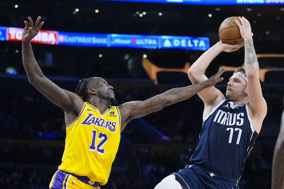 Dallas Mavericks guard Luka Doncic (77) shoots over Los Angeles Lakers forward Taurean Prince (12) during the first half of an NBA basketball game Wednesday, Jan. 17, 2024, in Los Angeles. (AP Photo/Marcio Jose Sanchez)