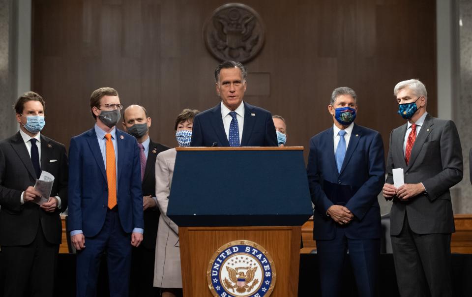 Sen. Mitt Romney (R-Utah), center, speaks alongside a group of Democrat and Republican members of Congress as they announce a proposal for a COVID-19 relief bill on Dec. 1. (Photo: SAUL LOEB via Getty Images)