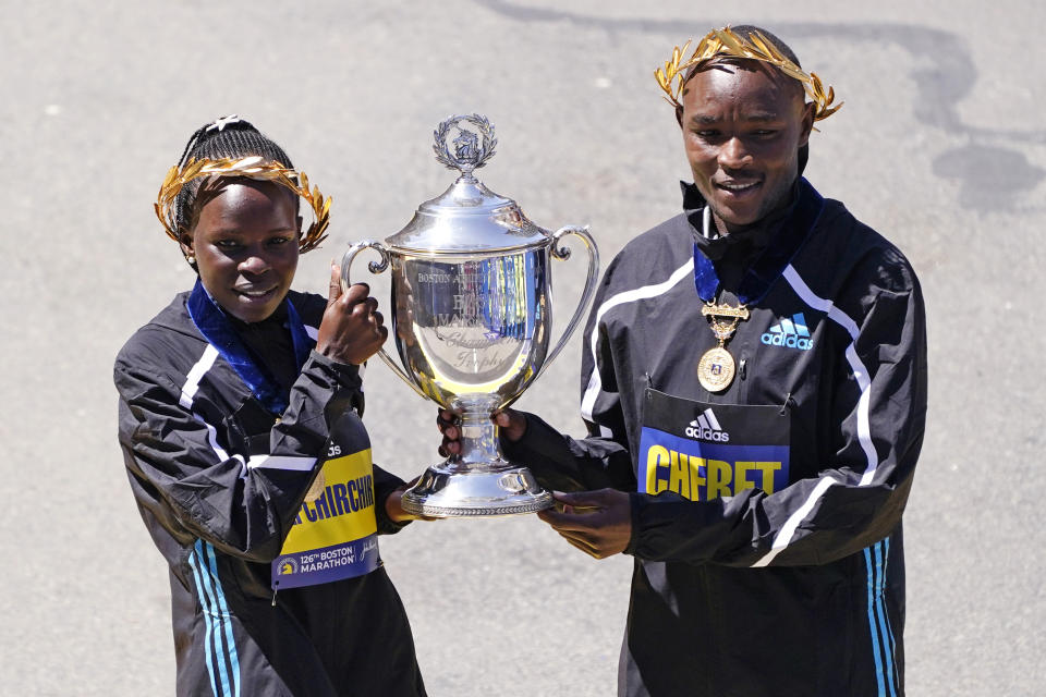 Boston Marathon women's division winner Peres Jepchirchir, of Kenya, left, and men's winner Evans Chebet, of Kenya, pose at the finish line Monday, April 18, 2022, in Boston. (AP Photo/Charles Krupa)