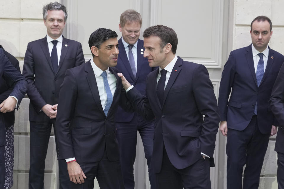 French President Emmanuel Macron, centre right, and Britain's Prime Minister Rishi Sunak, centre left, talk after a group picture with ministers during a French-British summit at the Elysee Palace in Paris, Friday, March 10, 2023. French President Emmanuel Macron and British Prime Minister Rishi Sunak meet for a summit aimed at mending relations following post-Brexit tensions, as well as improving military and business ties and toughening efforts against Channel migrant crossings. (AP Photo/Kin Cheung, Pool)