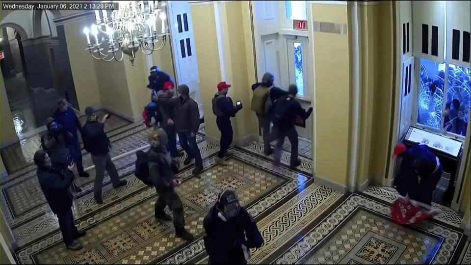 This exhibit from video released by the House Select Committee, shows security video of rioters entering the Capitol on Jan. 6, displayed at a hearing by the House select committee investigating the Jan. 6 attack on the U.S. Capitol, Thursday, July 21, 2022, on Capitol Hill in Washington. (House Select Committee via AP)