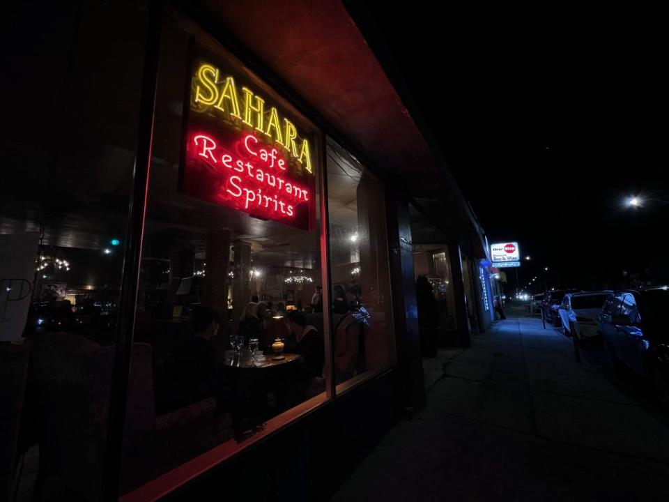 The Sahara Restaurant's neon glows on its final night Friday along Highland Street. The Middle Eastern eatery has closed after more than 20 years in the city.