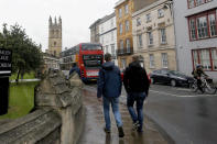 FILE - In this Sept. 3, 2017, file photo, people walk around Oxford University's campus in Oxford, England. Tax and charity records show that prestigious universities around the world, including Oxford, have accepted at least $60 million from the family that owns OxyContin maker Purdue Pharma over the past five years, even as the company has been embroiled in lawsuits over its role in the opioid epidemic. (AP Photo/Caroline Spiezio, File)