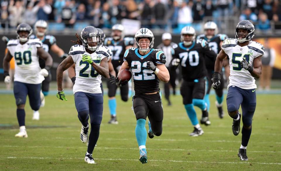Carolina Panthers running back Christian McCaffrey leaves a host of Seattle Seahawks in his wake in a 2018 game in Charlotte.
