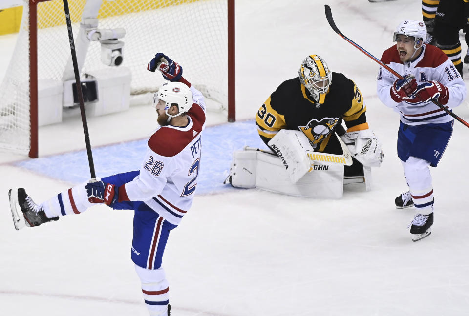 Montreal Canadiens defenseman Jeff Petry (26) celebrates along with right wing Brendan Gallagher (11) after scoring against Pittsburgh Penguins goaltender Matt Murray (30) during overtime in an NHL hockey playoff game in Toronto, Saturday, Aug. 1, 2020. (Nathan Denette/The Canadian Press via AP