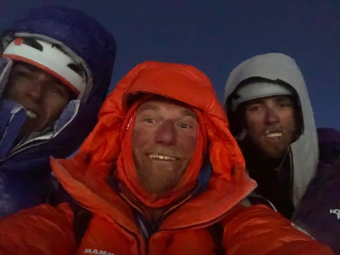 Three climbers on the summit of Denali.