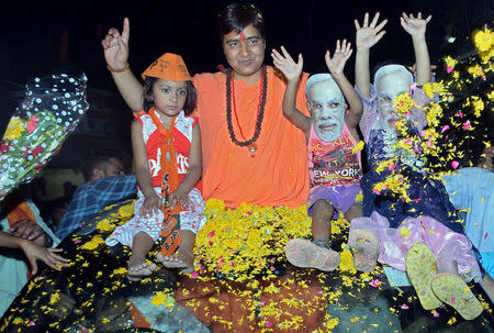 FILE PHOTO: Pragya Thakur, a Bharatiya Janata Party (BJP) candidate in the parliamentary election, gestures atop a car during her election campaign rally in Bhopal, India, April 30, 2019. REUTERS/Raj Patidar/File Photo