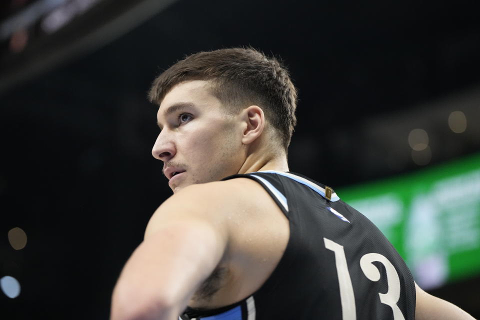 Atlanta Hawks guard Bogdan Bogdanovic (13) walks on the court against the Memphis Grizzlies during the first half of an NBA basketball game, Saturday, Dec. 23, 2023, in Atlanta. (AP Photo/Mike Stewart)