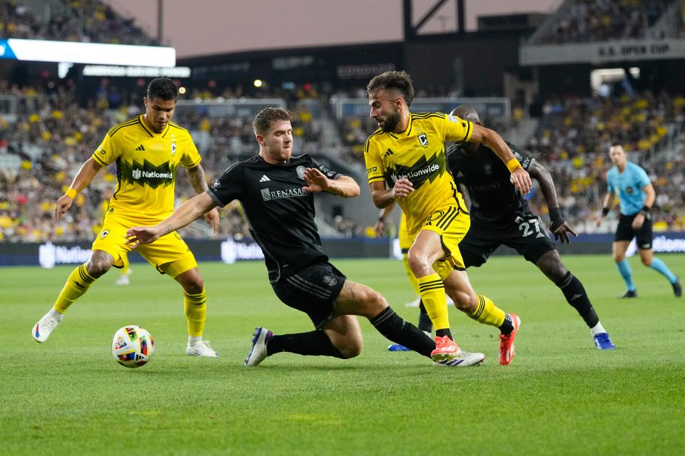 Jul 3, 2024; Columbus, OH, USA; Columbus Crew forward Diego Rossi (10) dribbles past Nashville SC defender Josh Bauer (22) during the first half of the MLS soccer game at Lower.com Field. Mandatory Credit: Adam Cairns-The Columbus Dispatch