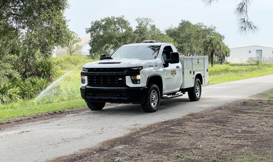 A truck sprays larvicide into a ditch (Lee County Mosquito Control District)