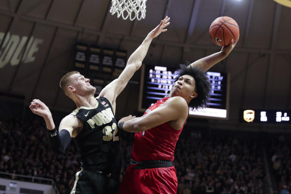 Rutgers guard Ron Harper Jr. (24) goes up for a dunk over Purdue center Matt Haarms (32) during the first half of an NCAA college basketball game in West Lafayette, Ind., Saturday, March 7, 2020. (AP Photo/Michael Conroy)