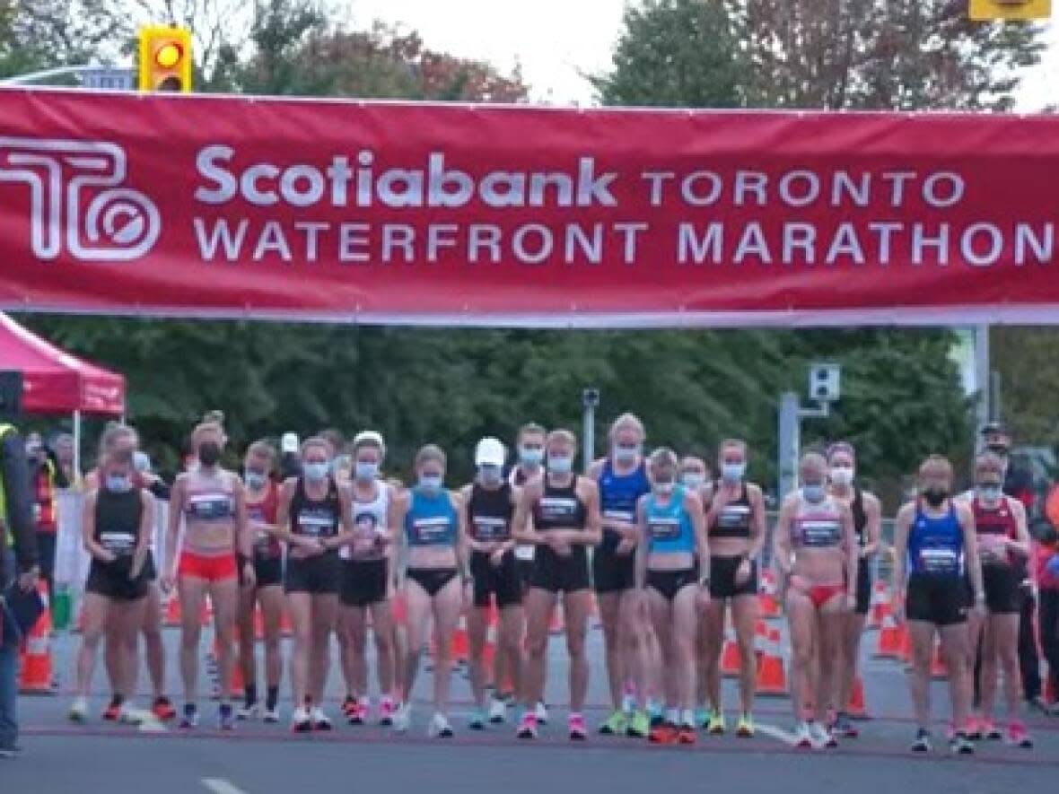 According to the Canada Running Series, about 5,000 participants were expected at the Scotiabank Toronto Waterfront Marathon's 10K race on Sunday. Here are female runners at the start line of the women's elite 10K race. (YouTube - image credit)