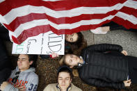 <p>Anna Hurley, 15, of Washington, top, and other demonstrators participate in a “lie-in” during a protest in favor of gun control reform in front of the White House, Monday, Feb. 19, 2018, in Washington. (Photo: Evan Vucci/AP) </p>