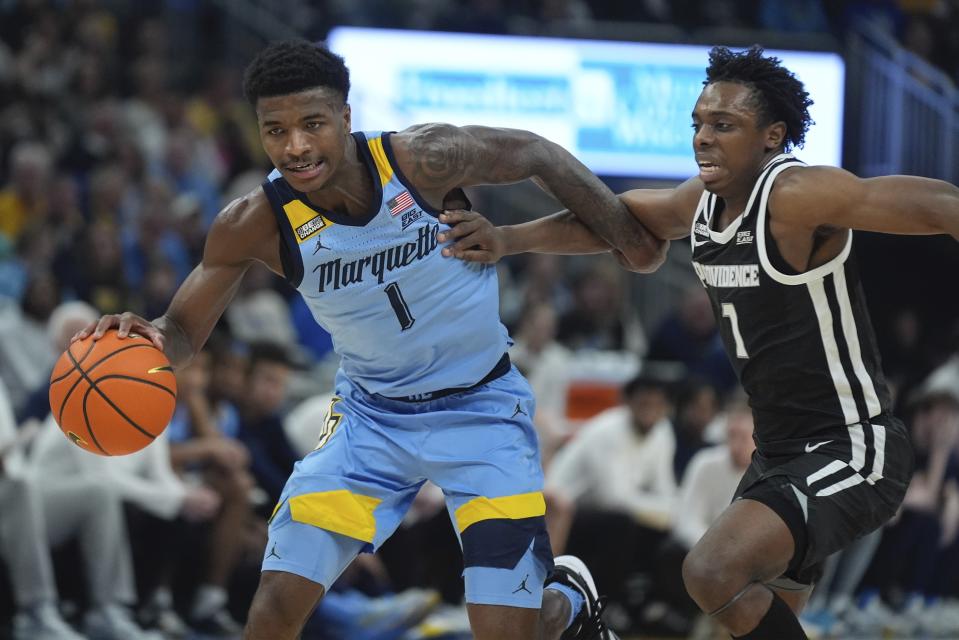 Marquette's Kam Jones gets past Providence's Jayden Pierre during the first half of an NCAA college basketball game Wednesday, Feb. 28, 2024, in Milwaukee. (AP Photo/Morry Gash)