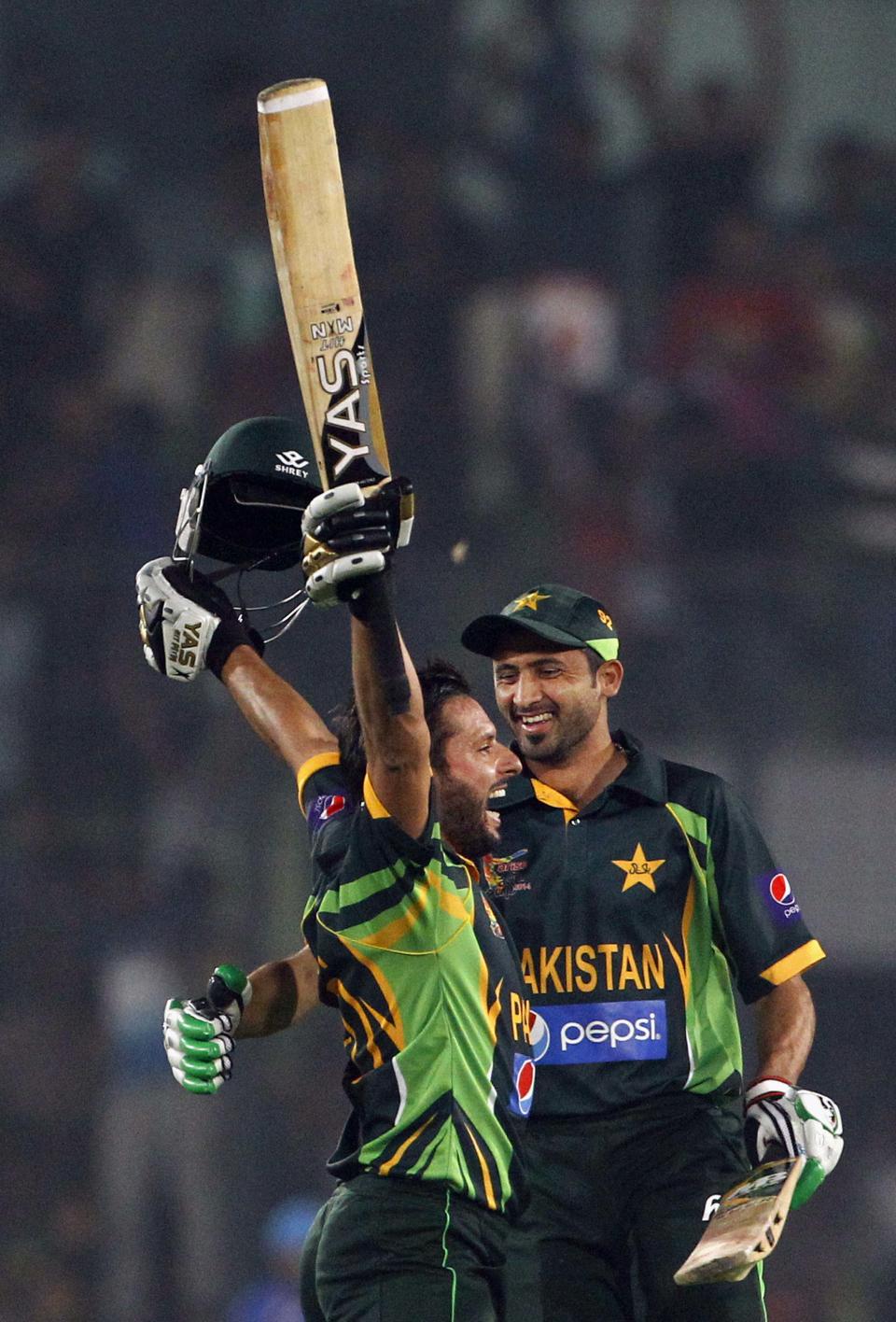 Pakistan’s Shahid Afridi, left, celebrates with a teammate after winning the Asia Cup one-day international cricket tournament against India in Dhaka, Bangladesh, Sunday, March 2, 2014. Pakistan won by 1 wicket. (AP Photo/A.M. Ahad)