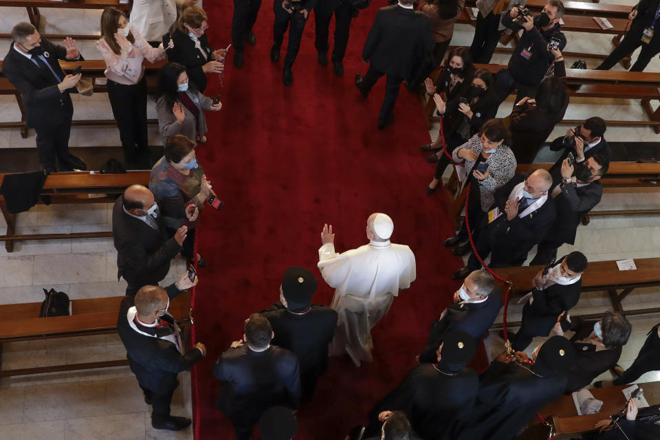 Pope Francis arrives for a meeting with bishops and priests, at the Sayidat al-Nejat (Our Lady of Salvation) Cathedral, in Baghdad, Iraq, Friday, March 5, 2021. Pope Francis has arrived in Iraq to urge the country's dwindling number of Christians to stay put and help rebuild the country after years of war and persecution, brushing aside the coronavirus pandemic and security concerns. (AP Photo/Andrew Medichini)