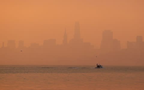 Smoke obscures the San Francisco skyline - Credit: AP