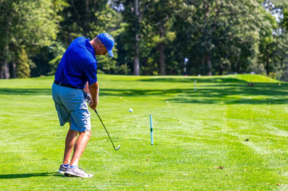 Chris Giusti uses an iron from the fairway on Hole 10 at the Country Club of New Bedford Fourball Tournament.