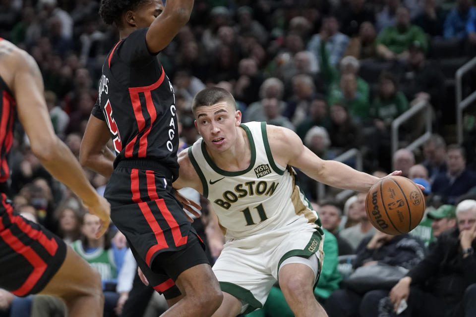 Boston Celtics guard Payton Pritchard (11) drives toward the basket in front of Chicago Bulls forward Julian Phillips (15) in the second half of an NBA In-Season Tournament basketball game, Tuesday, Nov. 28, 2023, in Boston. (AP Photo/Steven Senne)