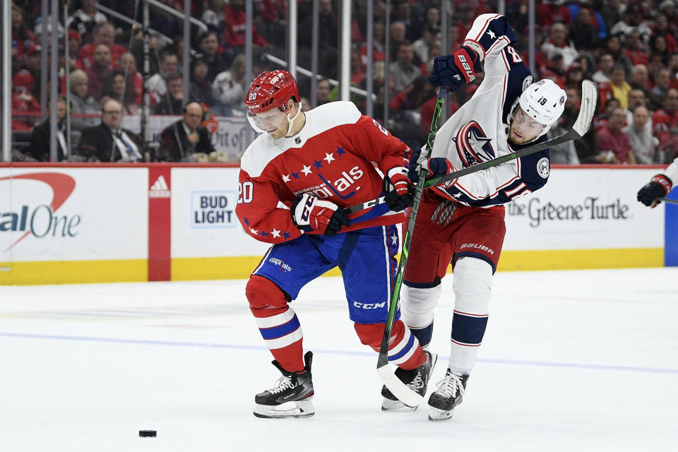 Washington Capitals center Lars Eller (20), of Denmark, and Columbus Blue Jackets center Pierre-Luc Dubois (18) vie for the puck during the first period of an NHL hockey game Friday, Dec. 27, 2019, in Washington. (AP Photo/Nick Wass)