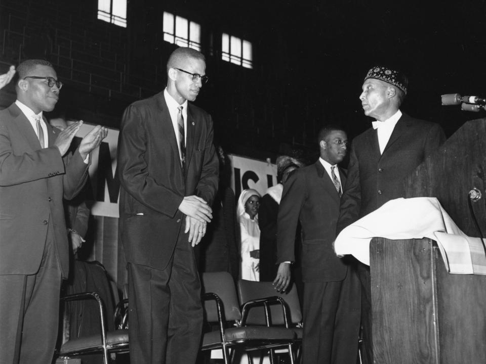 Elijah Muhammad, founder and head of the Nation of Islam, is shown at a lecturn in Chicago introducing Malcolm X on Feb. 26, 1961.