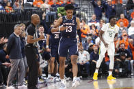 Virginia guard Ryan Dunn (13) celebrates after a play against Baylor during the second half of an NCAA college basketball game Friday, Nov. 18, 2022, in Las Vegas. (AP Photo/Chase Stevens)