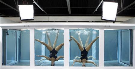 Synchronized swimmers present creations from the Adidas by Stella McCartney Spring/Summer 2014 collection during London Fashion Week September 17, 2013. REUTERS/Suzanne Plunkett