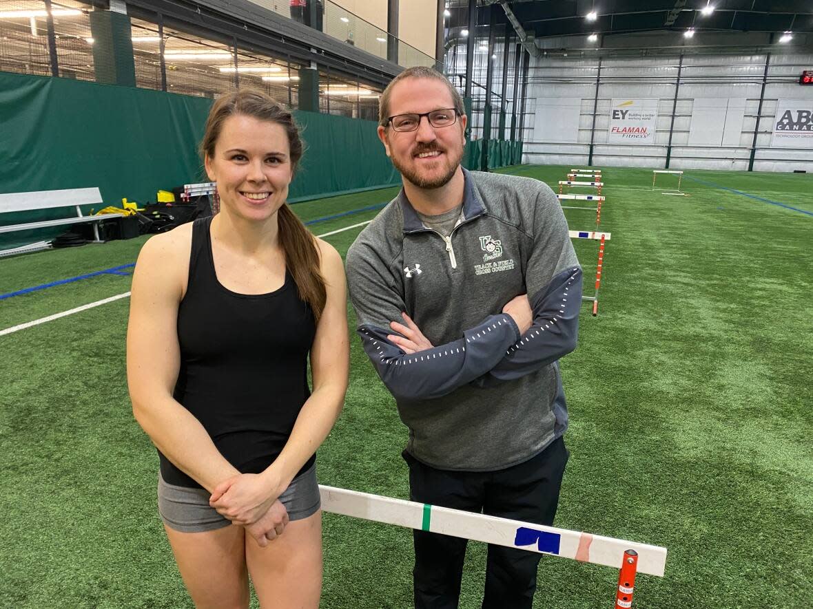 World class hurdler Michelle Harrison, left, with coach Jason Reindl, will compete against an international field in front of her home crowd this weekend at Saskatoon's historic Knights of Columbus Indoor Games. (Chanss Lagaden/CBC - image credit)